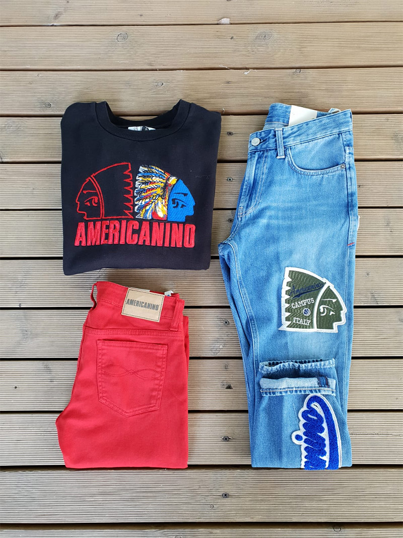 jeans, pantalone rosso e felpa americanino fotografate su sfondo di legno